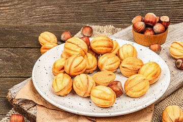 Cookies in the shape of walnuts with condensed milk cream filling.Delicious shortbread sandwiches