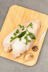 Raw chicken breast with spices and fresh parsley. Farm product, BIO poultry. Healthy food concept