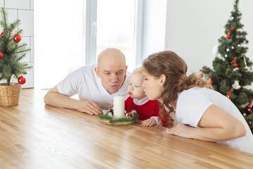Child girl dressed in christmas dress with cochlear implants having fun at home - diversity and hearing aid and innovating technologies for treatment of deafness.
