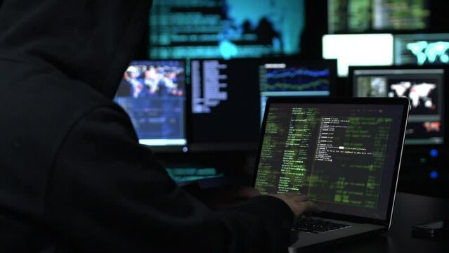 Hacker writing code on dark web