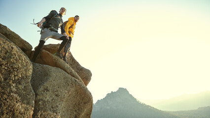 climbers on mountaintop - obrazy, fototapety, plakaty