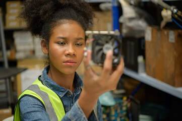 Female warehouse worker Counting items in an industrial warehouse on the factory's mezzanine floor. which is a storage for small and light electronic parts.