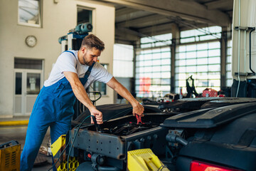 Professional truck mechanic working in vehicle repair service.
