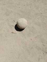 Fototapeta na wymiar Old ball on the sand