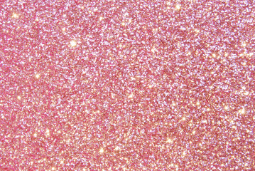 Pink de focused sparkle glitter background with golden particles