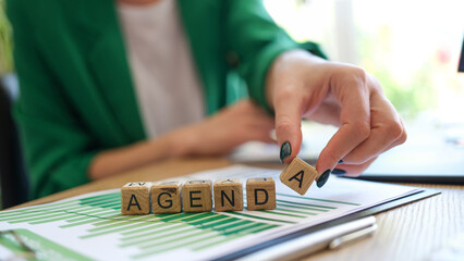 Manager woman adds letter to word agenda