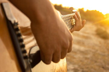 Guitar and sunset. Playing acoustic guitar during sunset. Playing music during sunset. Enjoying the...