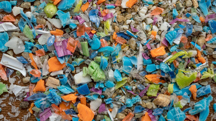 Close-up on micro plastic particles. The concept for water pollution and global warming. Macro shot on a bunch of microplastics that cannot be recycled.