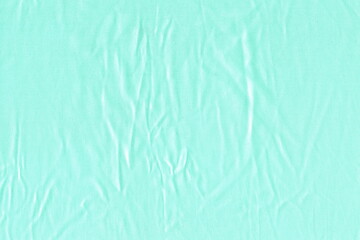 The texture of a natural light pale blue fabric. Light uneven crumpled fabric. Abstract background of light fabric.