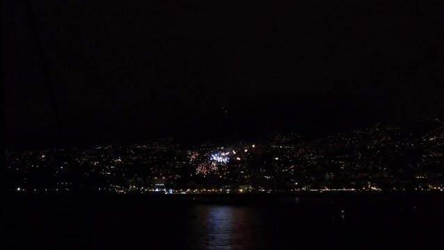Aerial shot of firework during nighttime in the city. Funchal June fireworks in Madeira. Concept travel. Aerial photo.