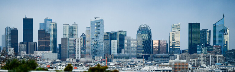 Panoramic view of the skyline of the financial district of La Défense, Paris, France (day time) with a blue sky in the background