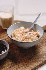 Homemade melted cheese curd served with baked milk and jam on wooden cutboard. Healthy breakfast. Haze effect. Selective focus