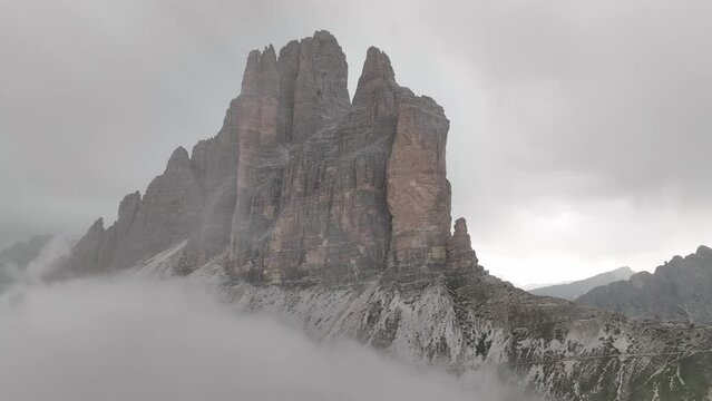 Beautiful cloudy day in Dolomites mountains. View on Tre Cime di Lavaredo - three famous mountain peaks that resemble chimneys.