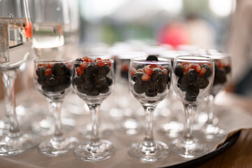 Frozen berries in a glass. Dessert for a party in a restaurant.