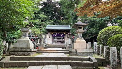 The Komagome Inari shrine with fox guardian angels in family numbers, the beautiful scenery up on the little hill of Nezu shrine, year 2022 June 29th