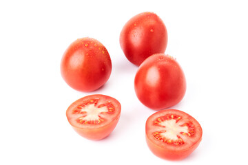 Three red ripe tomatoes soaked in water together with a tomato cut in half. Organic food