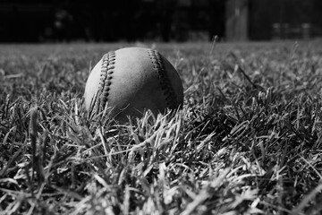 Baseball on foul line in field closeup.
