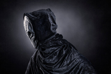 Mysterious humanoid alien at night over dark misty background