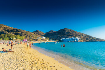 Fototapeta na wymiar Ios, Greece, 10 June 2022: Tourists enjoying Manganari beach