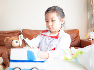 Asian children l girl role-playing as doctor