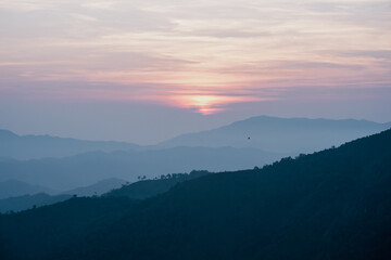 wide view  layer of mountain with sunrise background