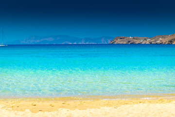 Fototapeta na wymiar Amazing crystal clear water of Manganari beach, Ios Island, Greece