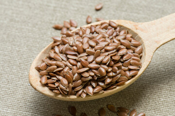 Wooden spoon with dried seeds of linen. Prepared for medical food, includes omega 3 acids.