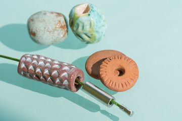 Handmade ceramic beads with steel rope on the craftsman's table.