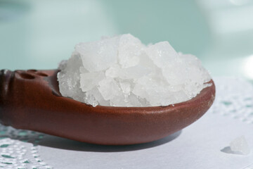 Spoon with sea salt, large white crystals.