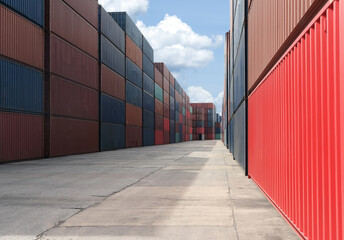 Row of stacking containers of freight importexport distribution warehouse with blue sky.