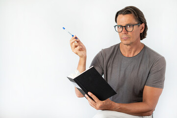 Mature educated man wearing glasses and reading a book