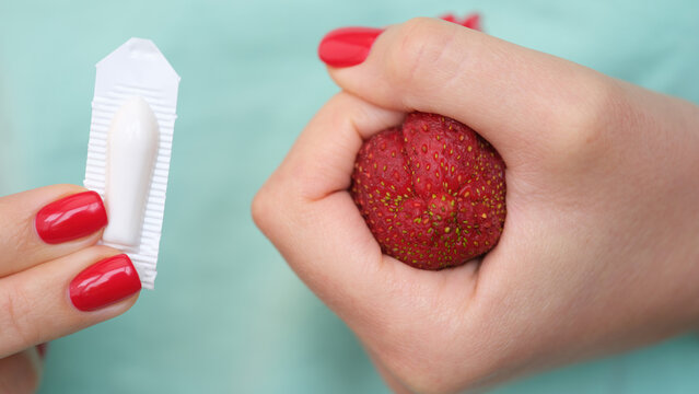 Woman hand holds medical candles for constipation and anatomy of anus