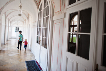 Brother with little sister walking at Veveri castle, Czech Republic.