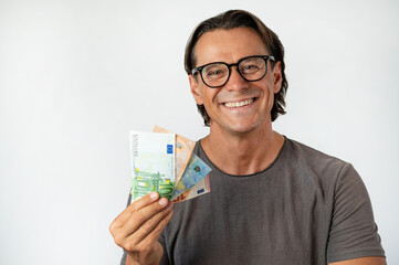 Happy and smiling middle aged man holding money by his face 
