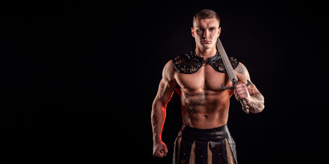 Antique warrior with sword against dark background
