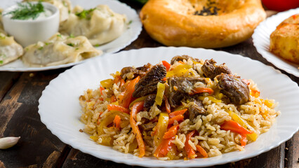 pilaf with beef and manti on wooden table macro close up