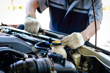 Auto mechanic is using wrench to repair and maintain engine. to customers who come to use the service. Concept of car care inspection and insurance. car garage