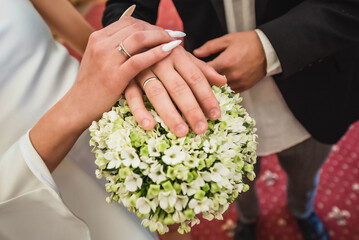 Hands. The bride and groom stand or go together in life. excitement before the wedding ceremony. family support.