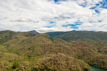 Fototapeta na wymiar Aerial view of road on the slopes of mountains among tropical vegetation. Sri Lanka.