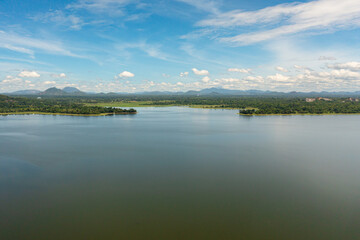 Aerial view of Sorabora lake in a mountain valley among the hills. Sri Lanka.