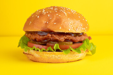 Burger with chicken, on a yellow background, bright background
