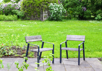 Two chairs on the relaxation area in the spring park. 