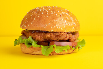 Burger with chicken, on a yellow background, bright background