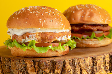 Burger with chicken, on a yellow background, bright background