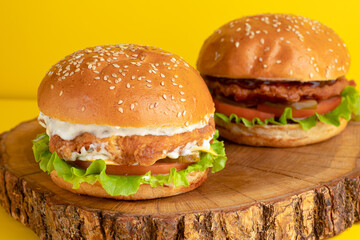 Burger with chicken, on a yellow background, bright background