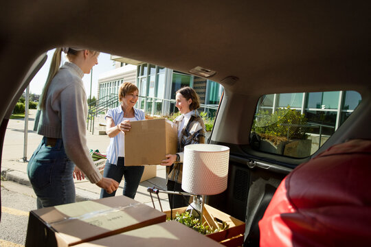 Mother Helping Daughter Move Into College Dormitory