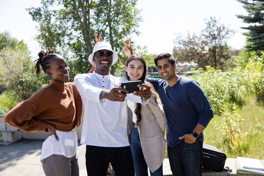 Happy College Friends Taking Selfie On Campus