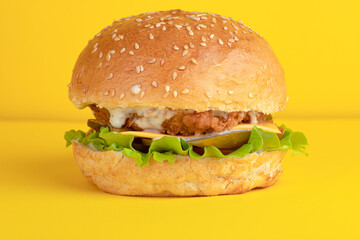 Burger with chicken, on a yellow background, bright background