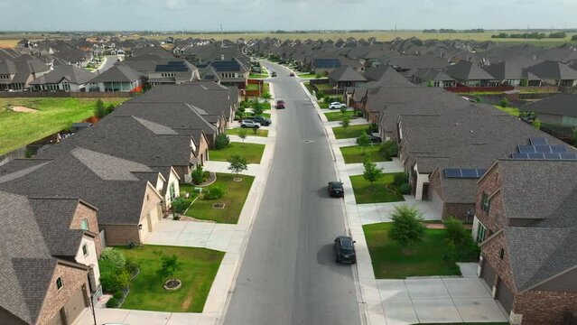 Reverse aerial above homes in American community. Residential single family houses in suburb in USA.