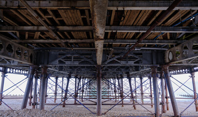 Fototapeta na wymiar Underneath Eastbourne Pier in East Sussex on the south coast of England